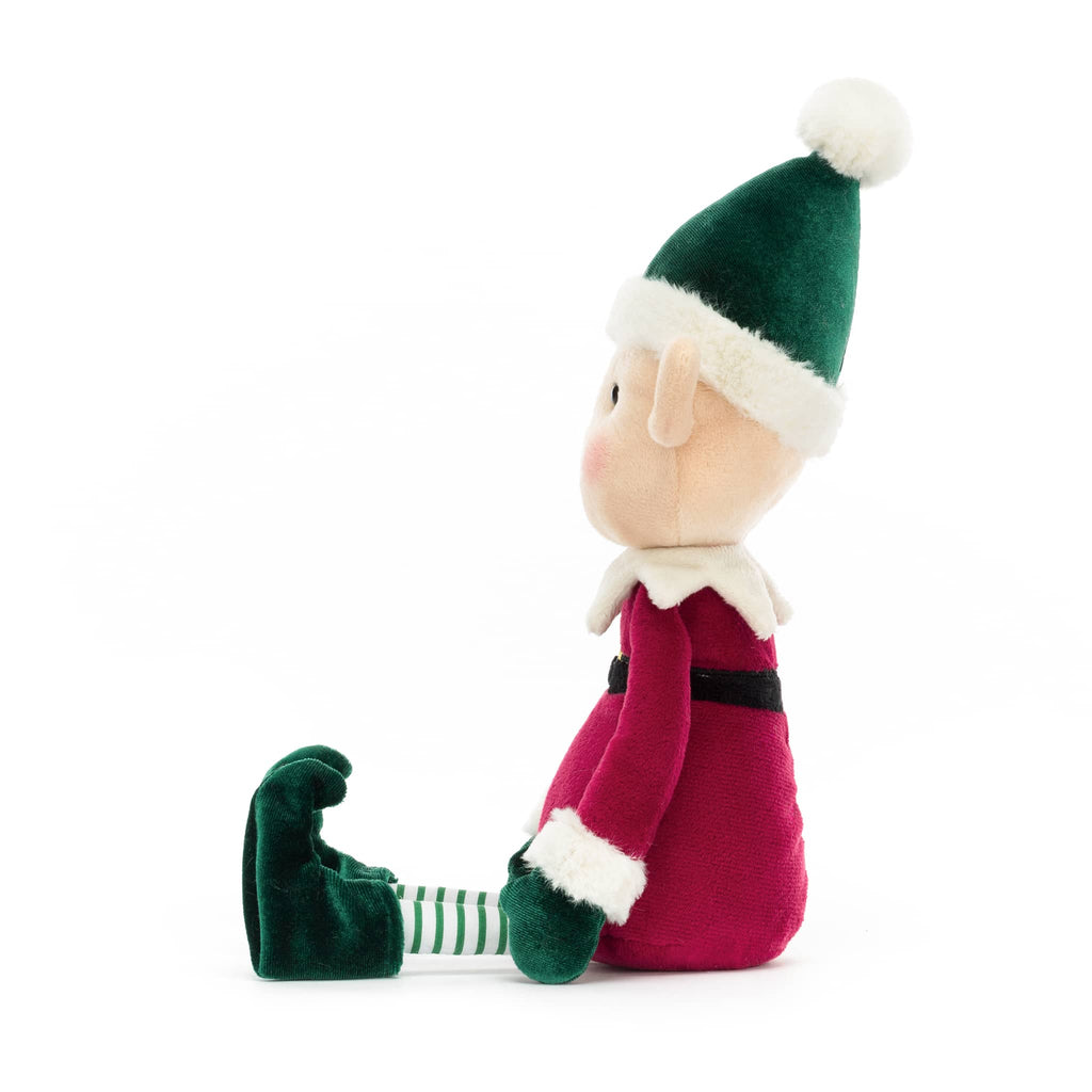 Plush toy elf with a green hat and red outfit, side view, on a white background.
