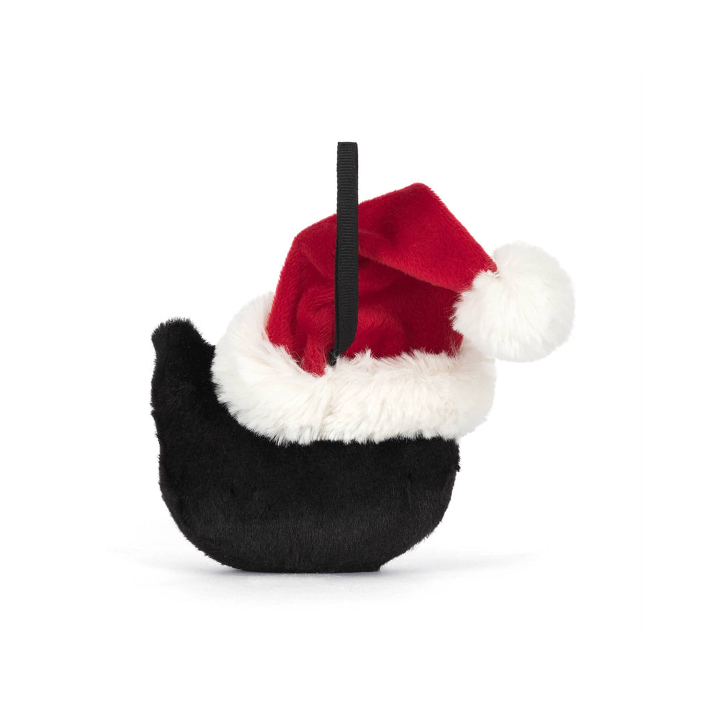 Plush black and white cat ornament with a santa hat, back view, on a white background.