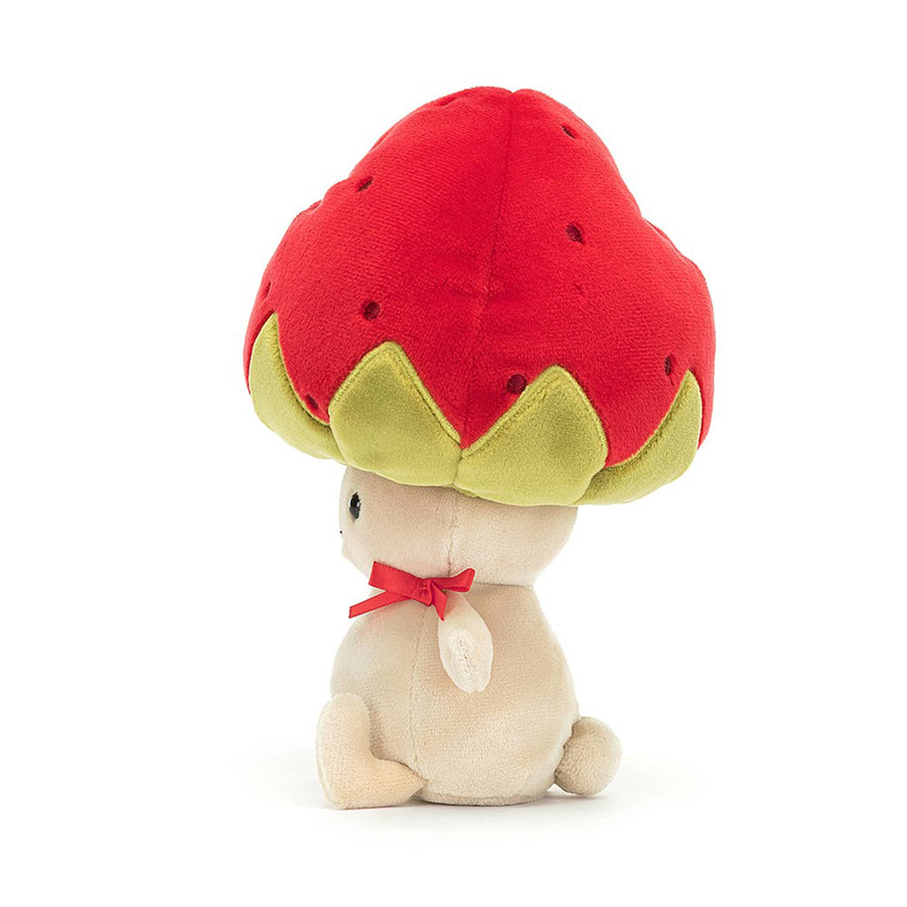 Jellycat Straw-Beret Sallie plush toy with a tan body and an upside down strawberry for a hat, side view.