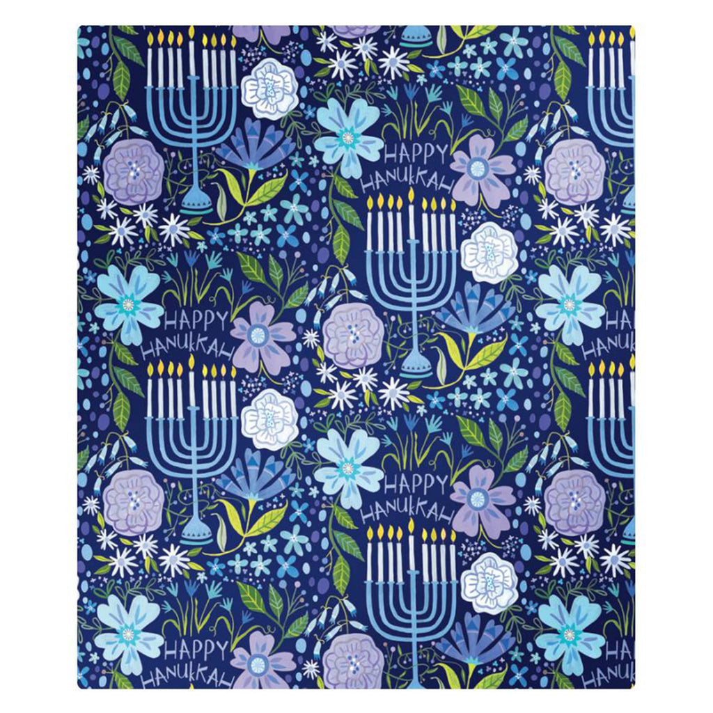 Wrapping paper roll with Hanukkah-themed design featuring menorahs, flowers, and 'Happy Hanukkah' text on a blue background.