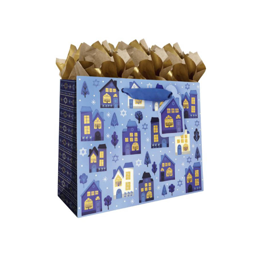 Gift bag with blue house pattern and gold tissue paper on a white background.