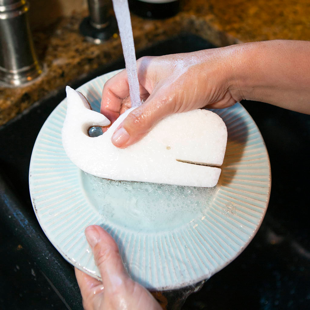 Kikkerland whale-shaped all-natural scrub sponge in use.