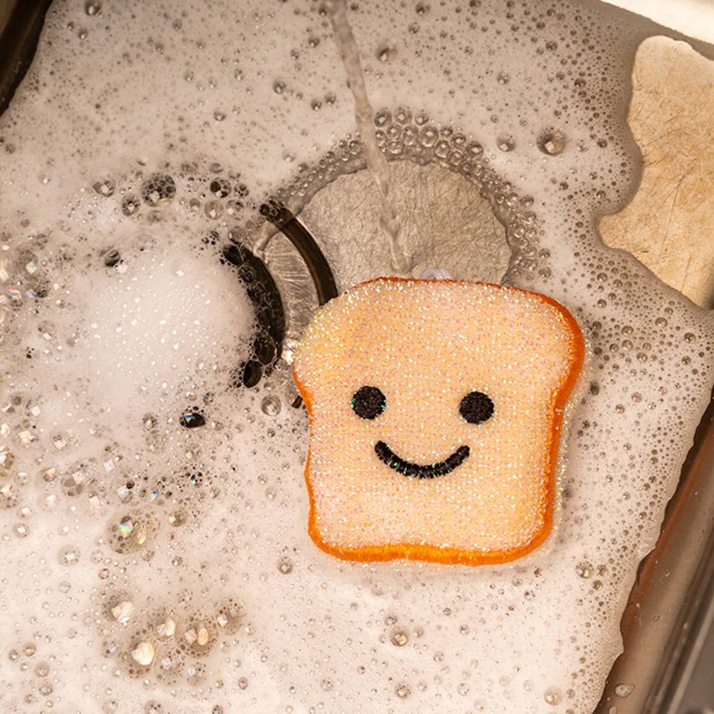 Kikkerland Toast Scrub Sponge, in soapy sink.