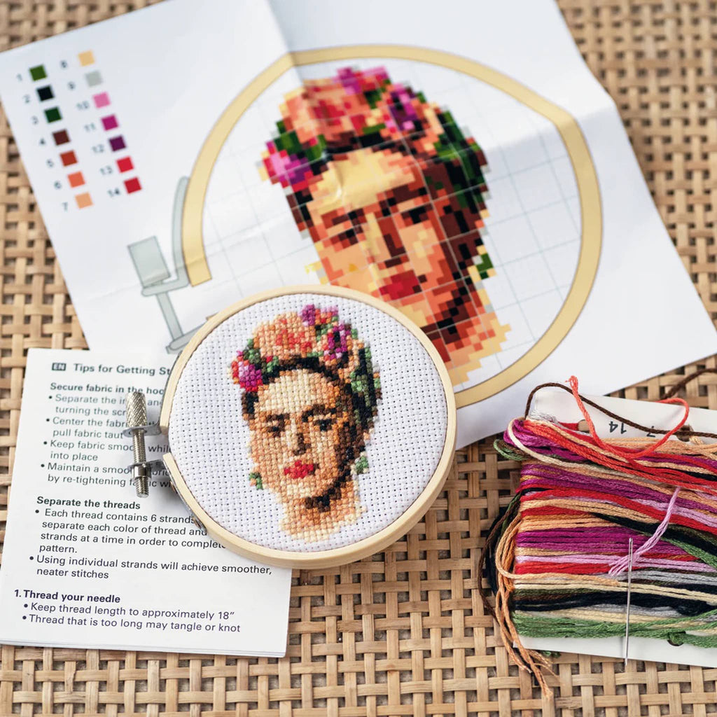 Kikkerland Frida Mini Cross Stitch Embroidery Kit completed hoop with kit contents.