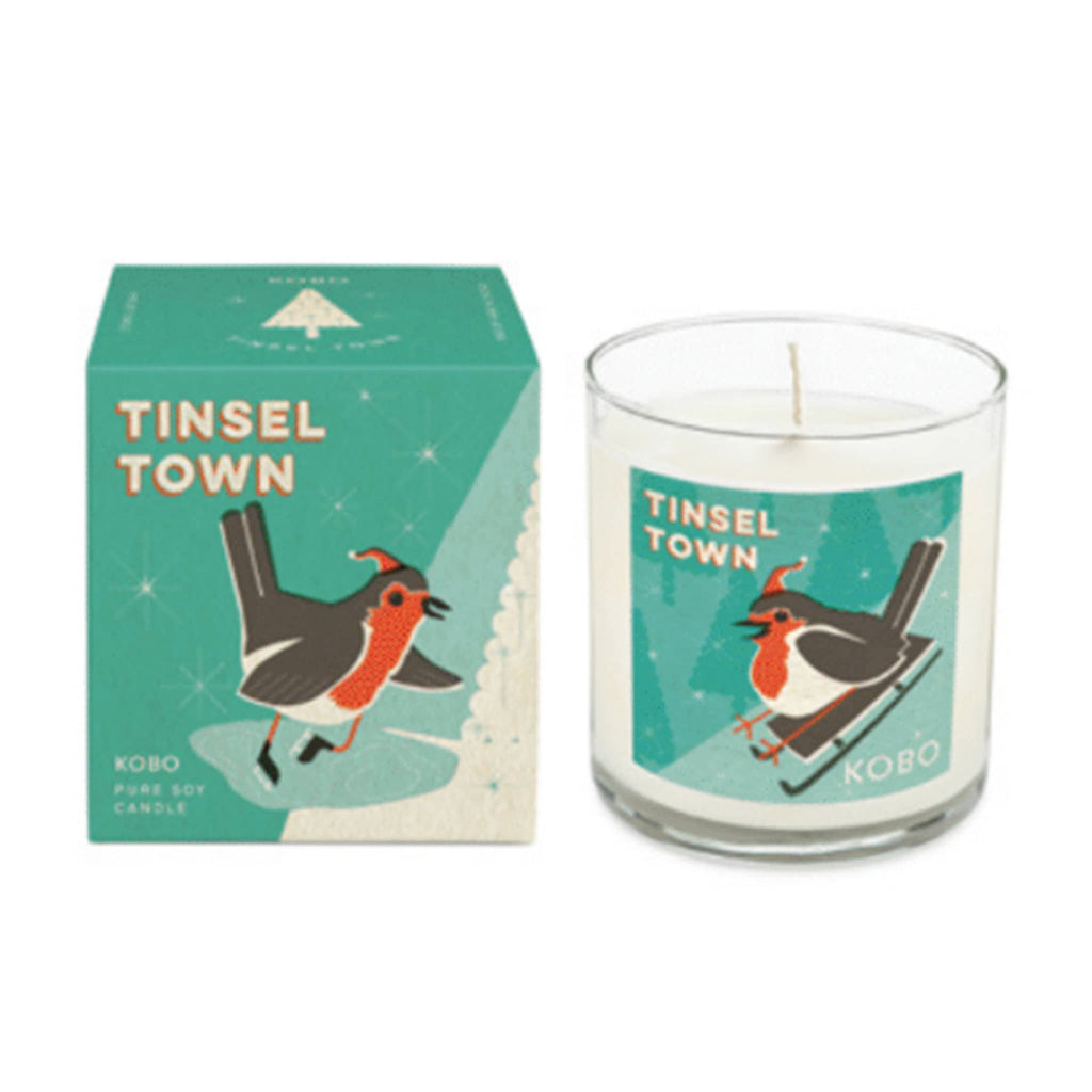 Kobo Candles Tinsel Town scented holiday candle in clear glass vessel with green label and matching illustration  gift box.