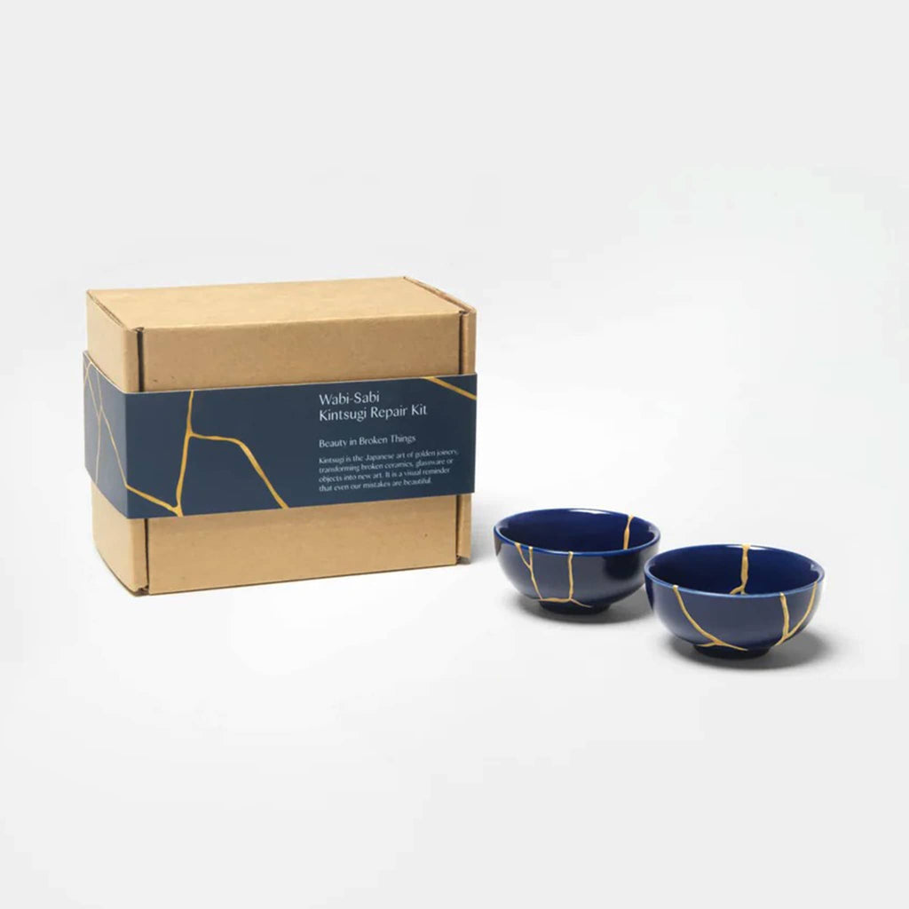 KonMari Wabi-Sabi Kintsugi Repair Kit in box packaging with finished indigo ceramic bowls with veins of gold.