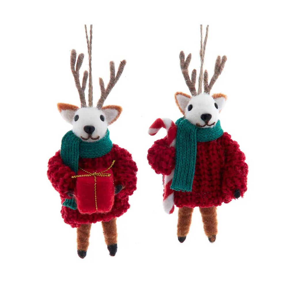 Two festive deer ornaments wearing red sweaters and green scarves on a white background.
