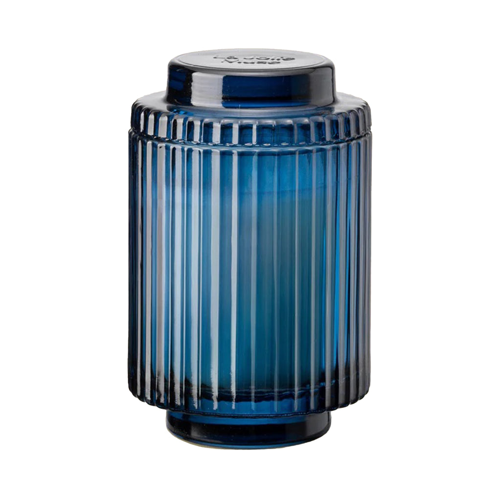 La Jolie Muse Amelie 11 ounce Eucalyptus Alpine Sage scented soy wax candle in ribbed blue glass vessel with lid.