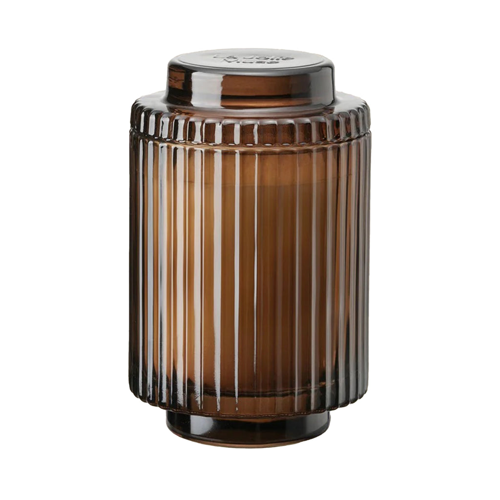 La Jolie Muse Amelie 11 ounce Saffron Oud scented soy wax candle in ribbed amber glass vessel with lid.