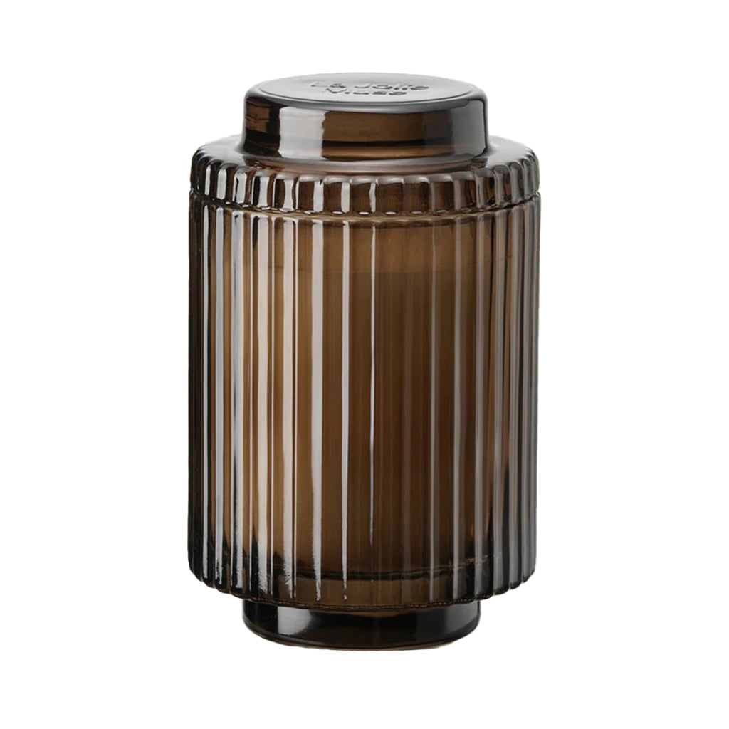 La Jolie Muse Amelie 11 ounce Santal Himalayen scented soy wax candle in ribbed brown glass vessel with lid.