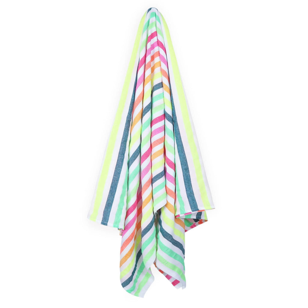 Las Bayadas La Gloria beach blanket towel with stripes in shades of pink, orange, green and white, hanging.