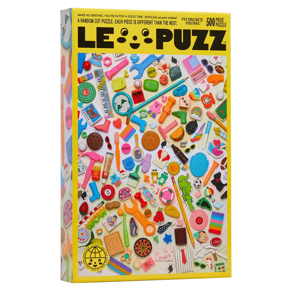 Le Puzz 500 piece My Favorite Mistake puzzle featuring a collection of vintage erasers in yellow box packaging, front view with puzzle image.