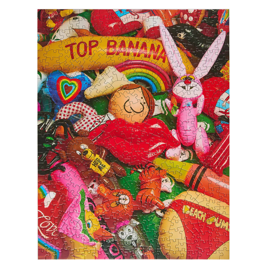 Colorful puzzle with various inflatables on a white background.