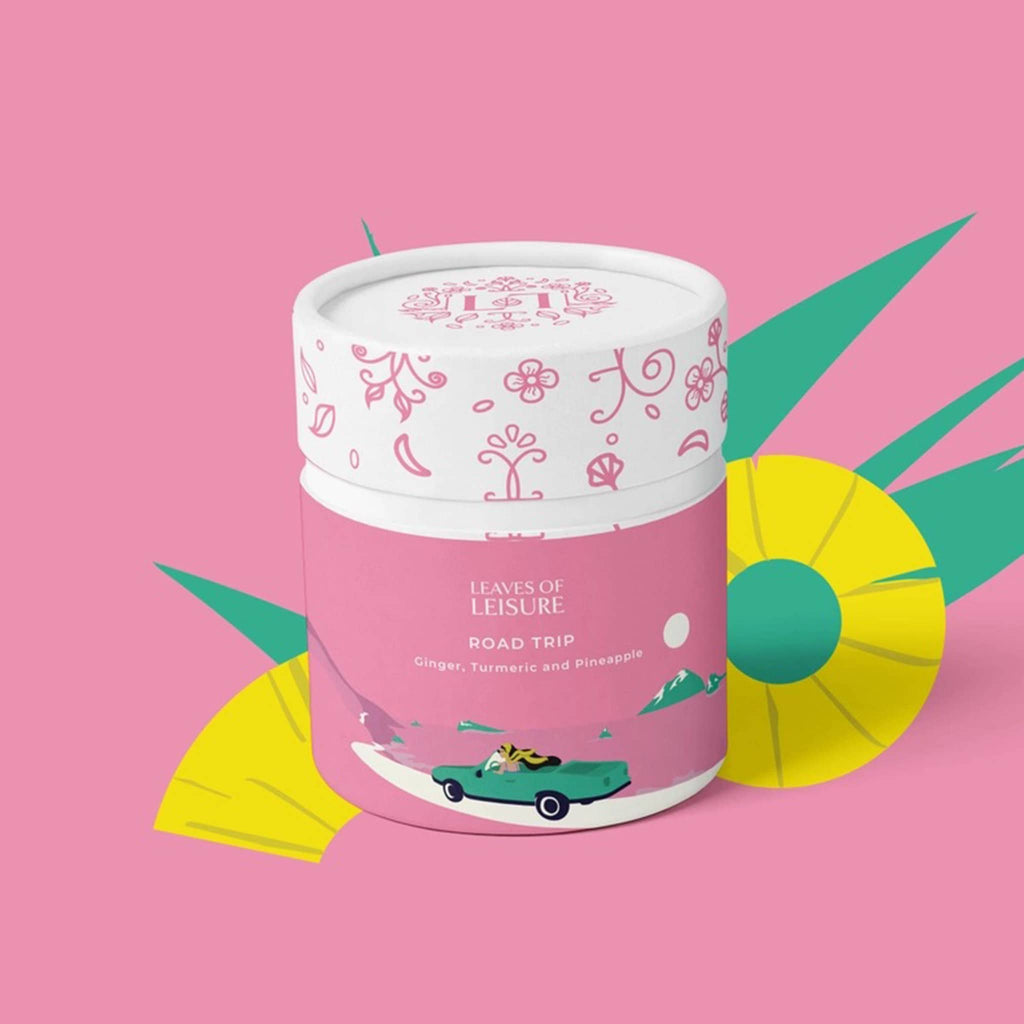 Leaves of Leisure Road Trip Caffeine-Free Organic Herbal Tea in illustrated pink canister packaging, front view, on pink background.