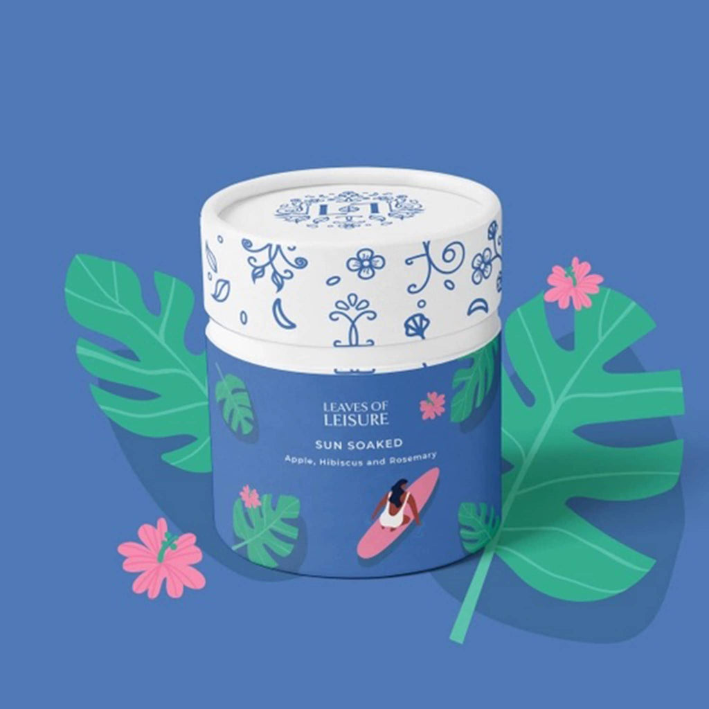 Leaves of Leisure Sun Soaked Low-Caffeine Organic Tea in illustrated blue canister packaging, front view, on blue background.