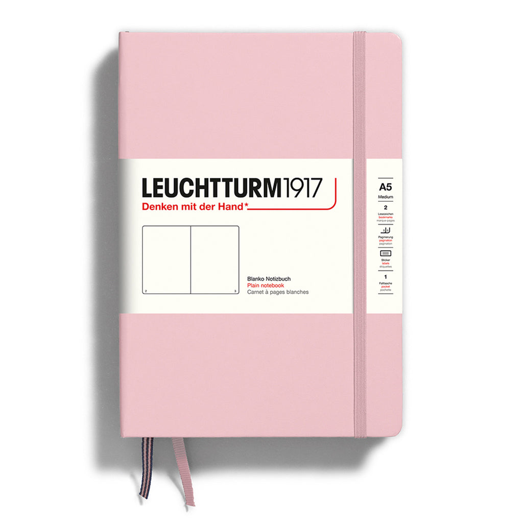 Leuchtturm1917 hardcover A5 medium notebook with plain pages and a powder pink cover and elastic band.