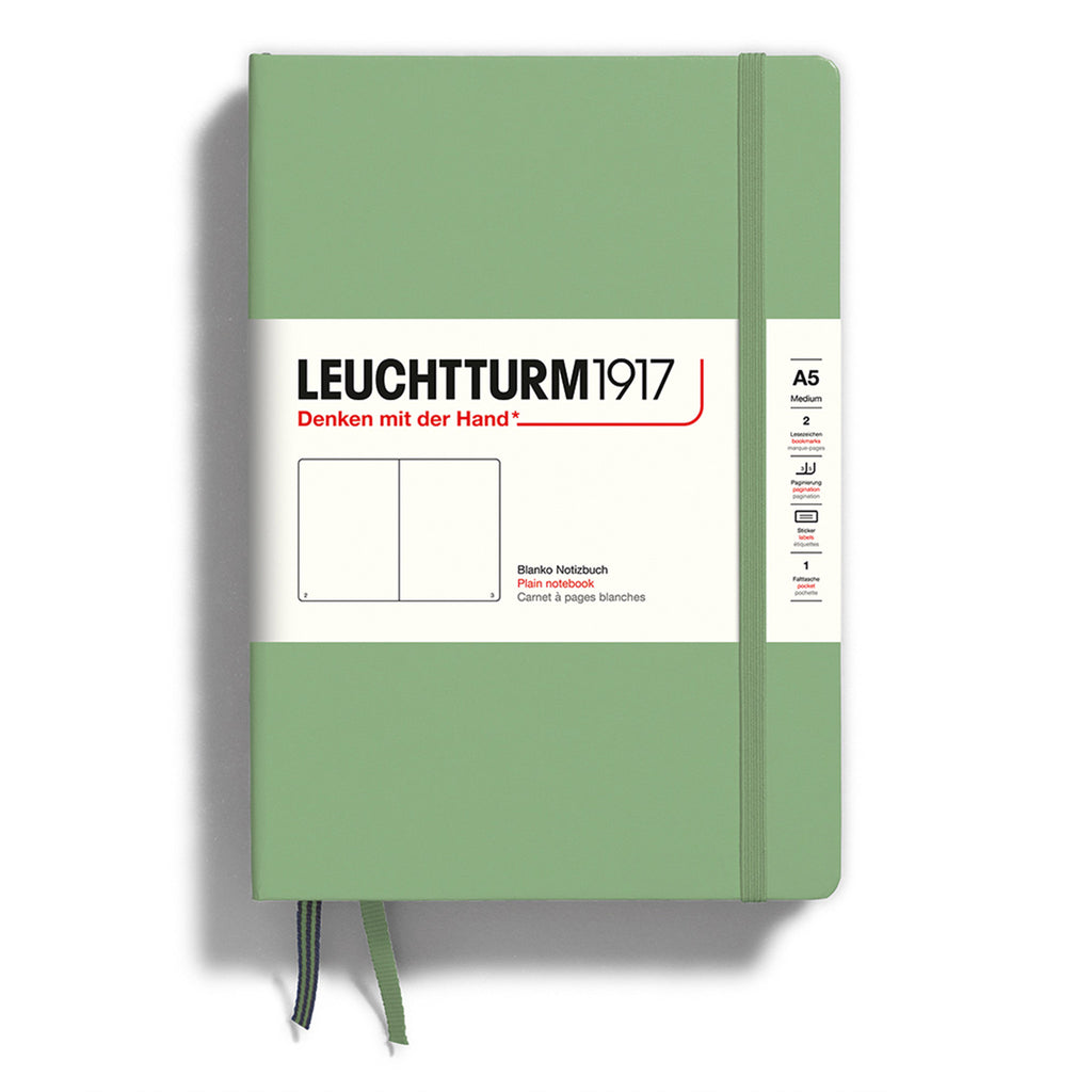 Leuchtturm1917 hardcover A5 medium notebook with plain pages and a sage green cover and elastic band.