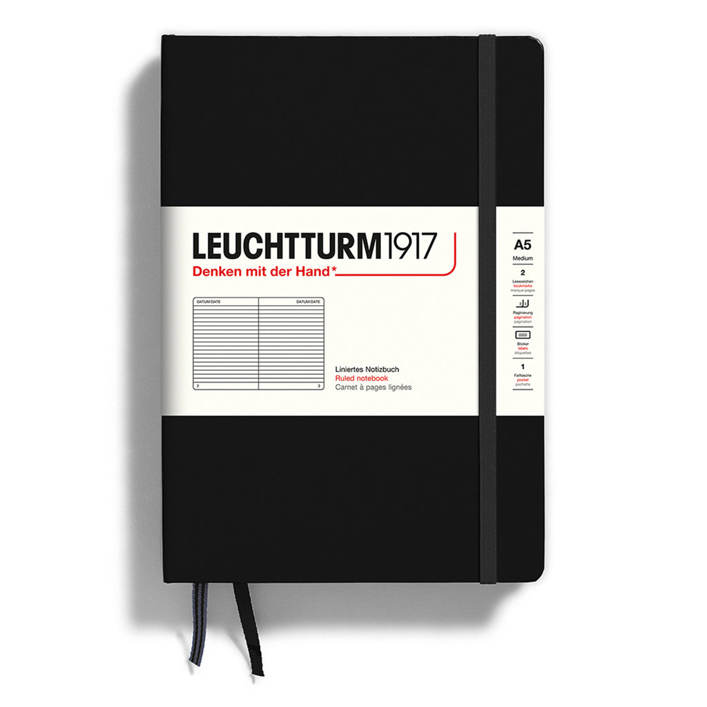 Leuchtturm1917 hardcover A5 medium notebook with ruled pages and a black cover and elastic band.