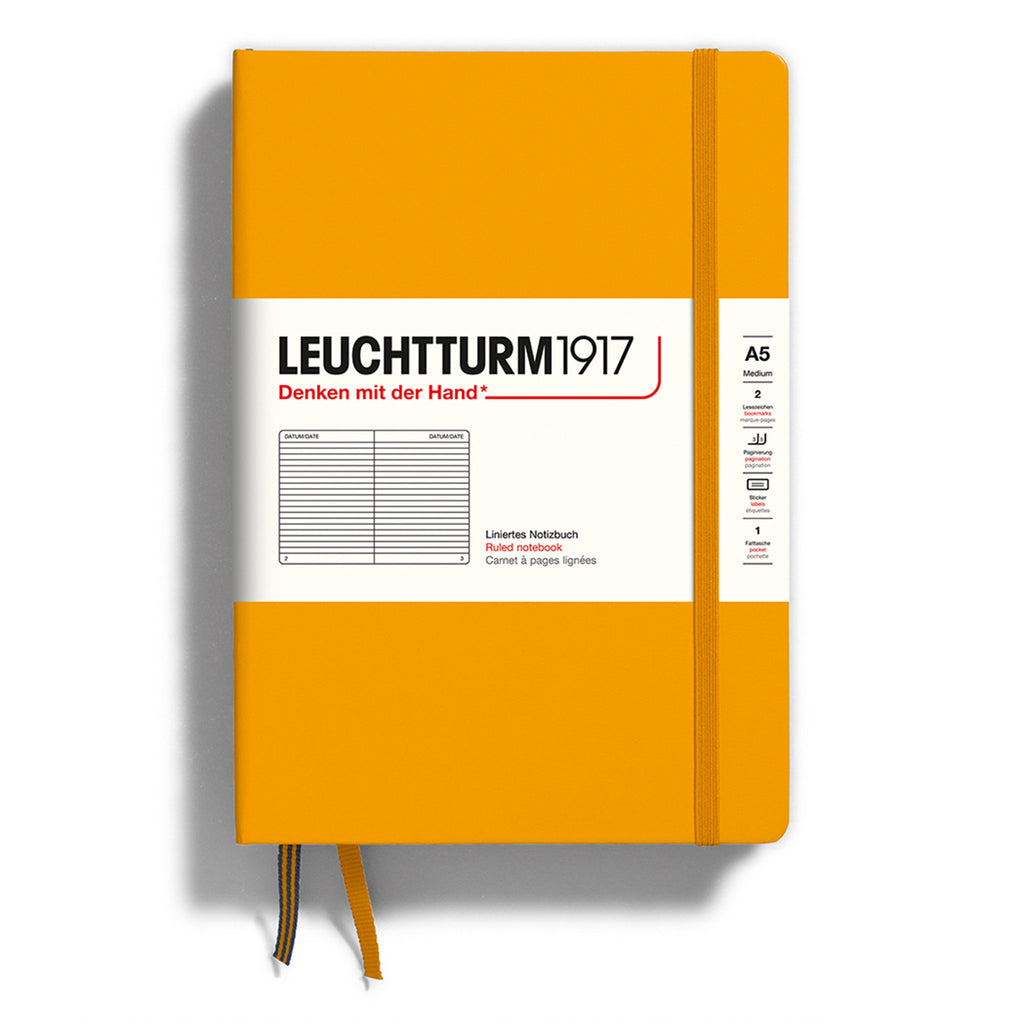 Leuchtturm1917 hardcover A5 medium notebook with plain pages and a rising sun (orange) cover and elastic band.