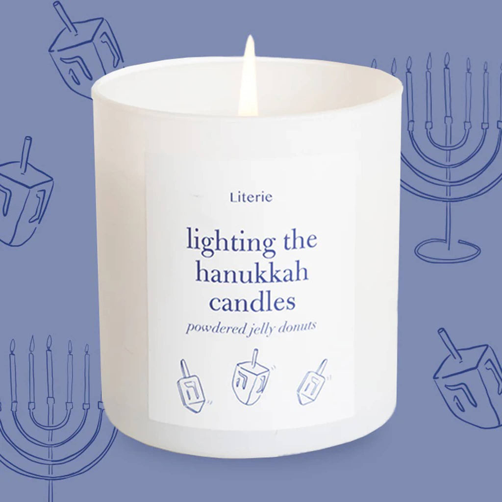 Lit candle with 'Literie' branding on a blue background with Hanukkah symbols.