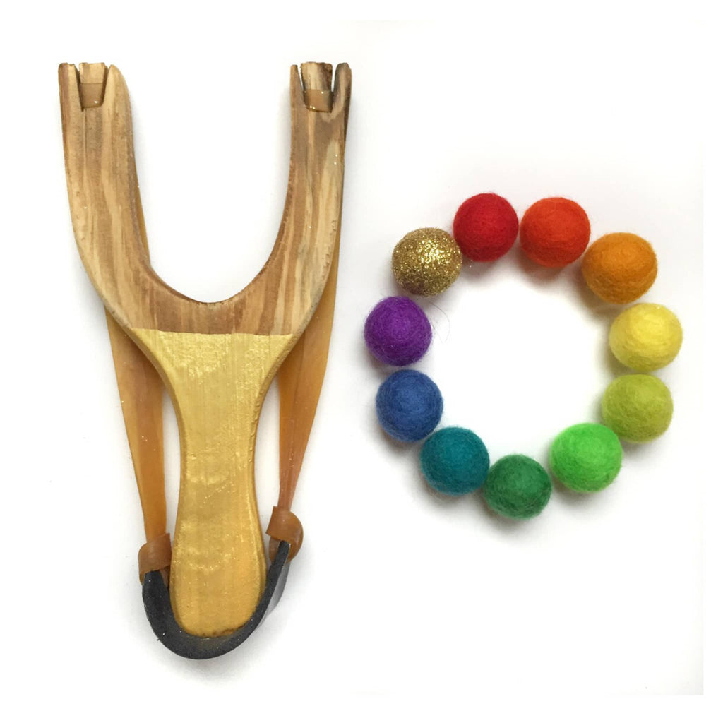 Little Lark Kids Deluxe wooden slingshot with gold handle and 1 gold glitter felt ball and 10 felt balls in rainbow colors.