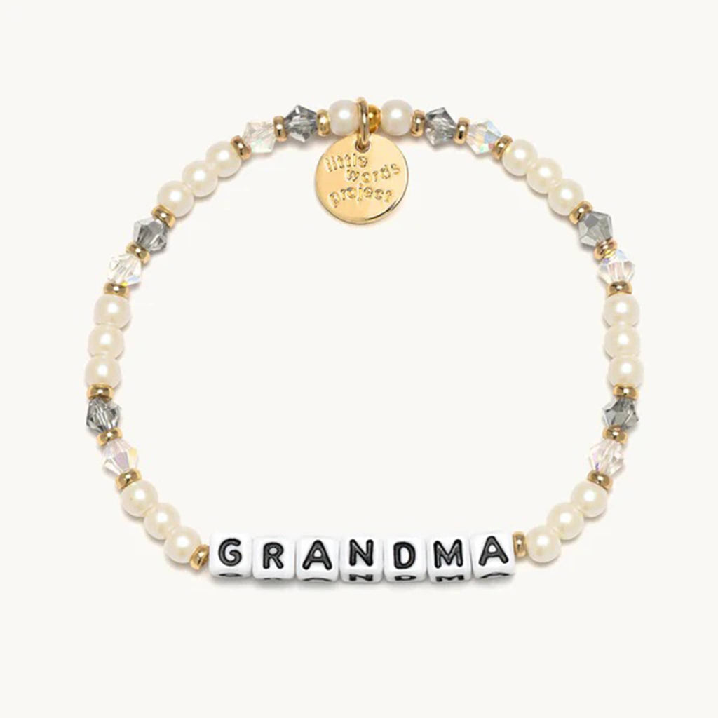 Little Words Project Grandma beaded elastic bracelet in strand of pearls bead design, faux cream pearls with white and gray translucent faux crystal beads, gold spacer beads and letter beads.