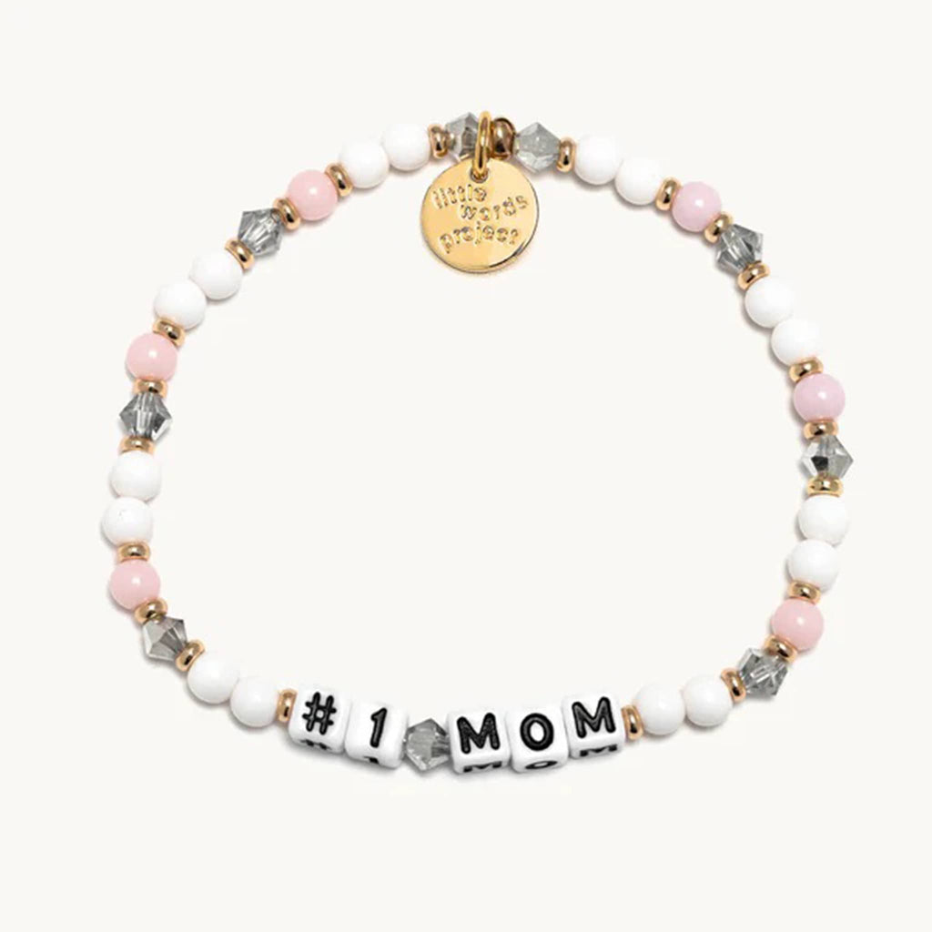 Little Words Project #1 Mom beaded elastic bracelet in dragon fruit bead design; white and pink beads with smoke gray translucent faux crystal beads with gold spacer beads and letter beads.