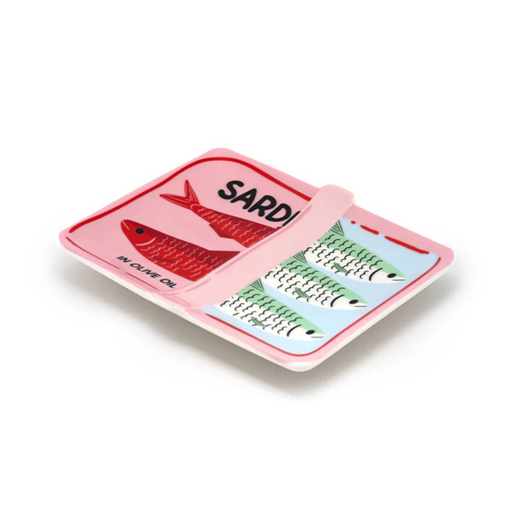 Ceramic trinket tray painted to look like a partially opened sardine can, side view on a white background.