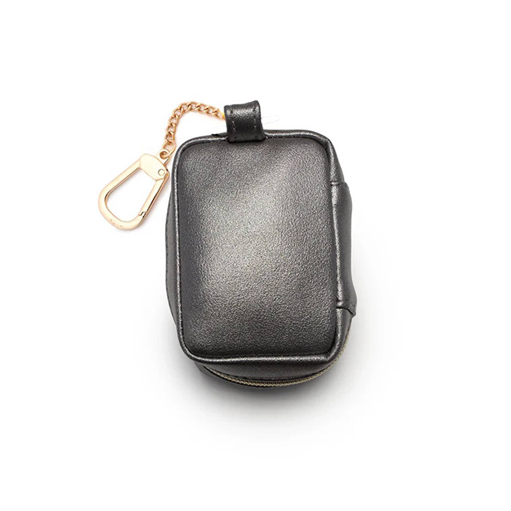 Black bag charm with gold chain on a white background.