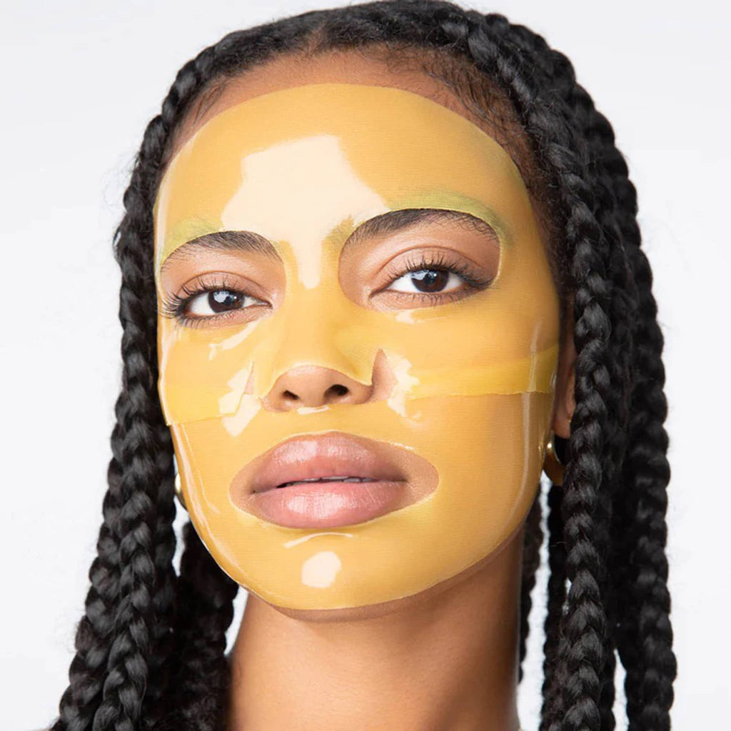 Woman wearing a yellow face mask on a white background.
