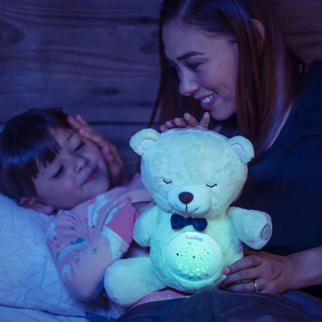 Lumieworld Lumipets Bear Nursery Sound Soother with night light, white plush bear with glowing belly with child and parent.