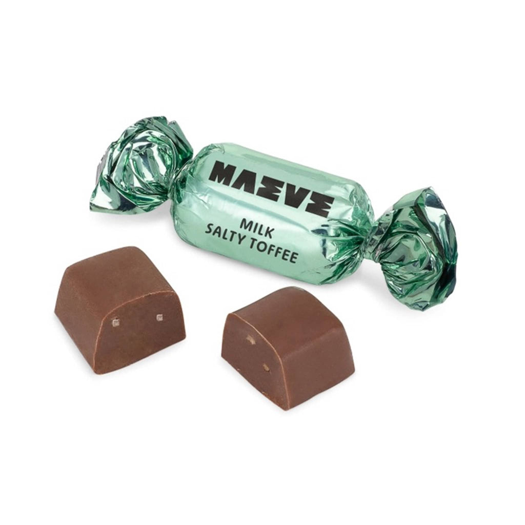 Maeve Milk Salty Toffee chocolate bonbon cut in half with light green foil wrapped piece, on a white background.