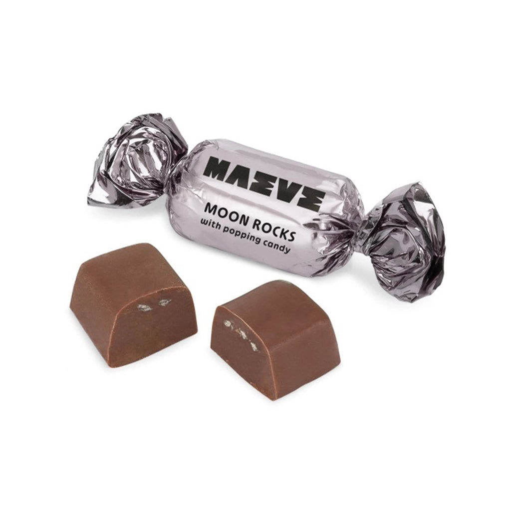Maeve Moon Rocks chocolate bonbon cut in half with light platinum foil wrapped piece, on a white background.
