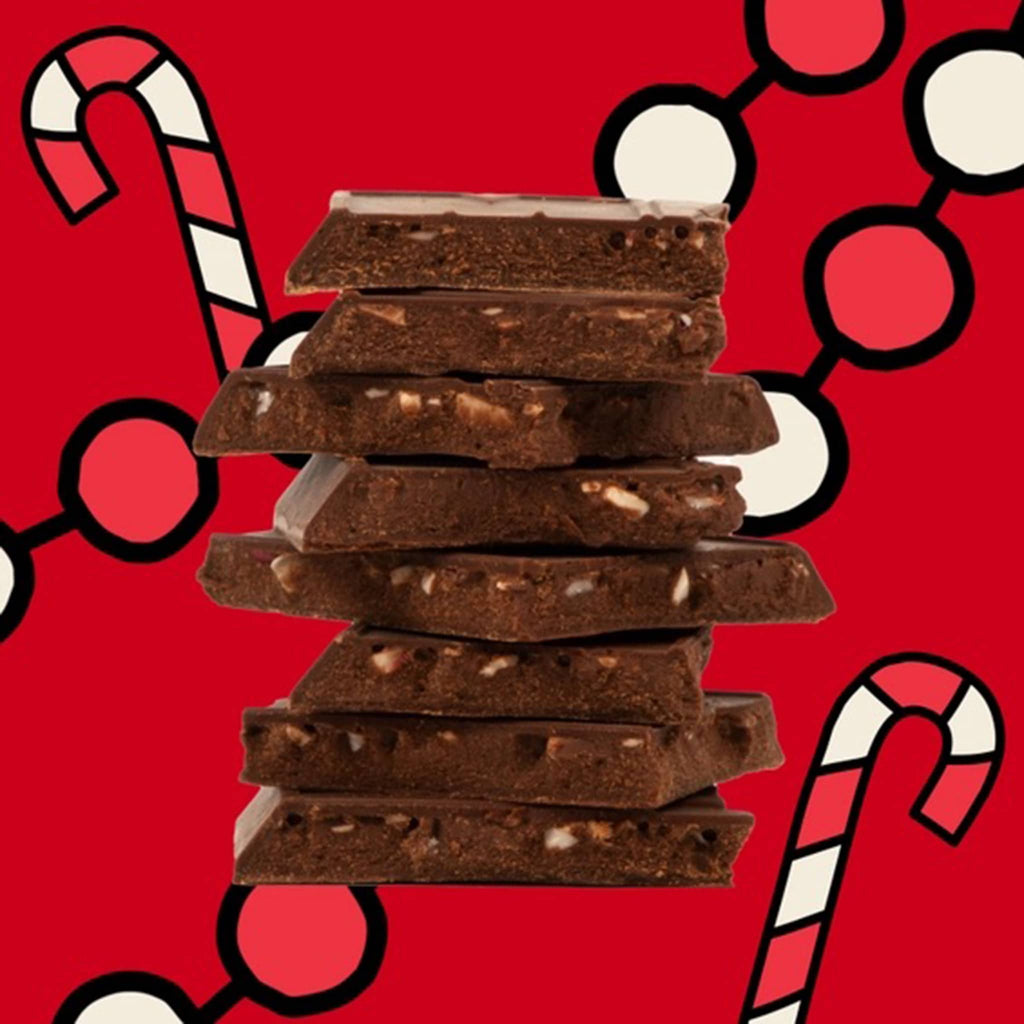 Maeve Candy Cane dark chocolate truffle bar, squares stacked to show inside on a red background.