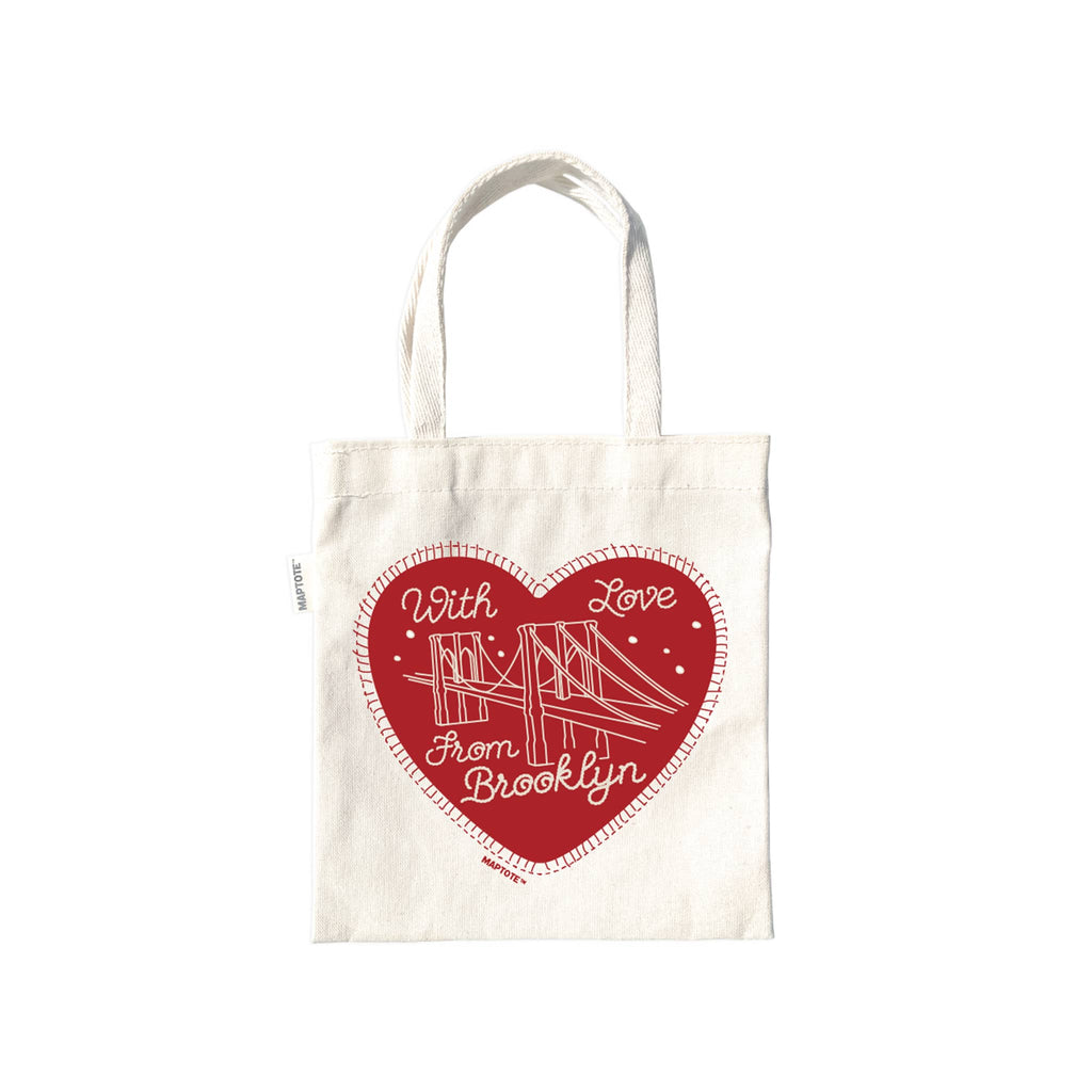 Tiny tote bag with a red heart design and text on a white background.