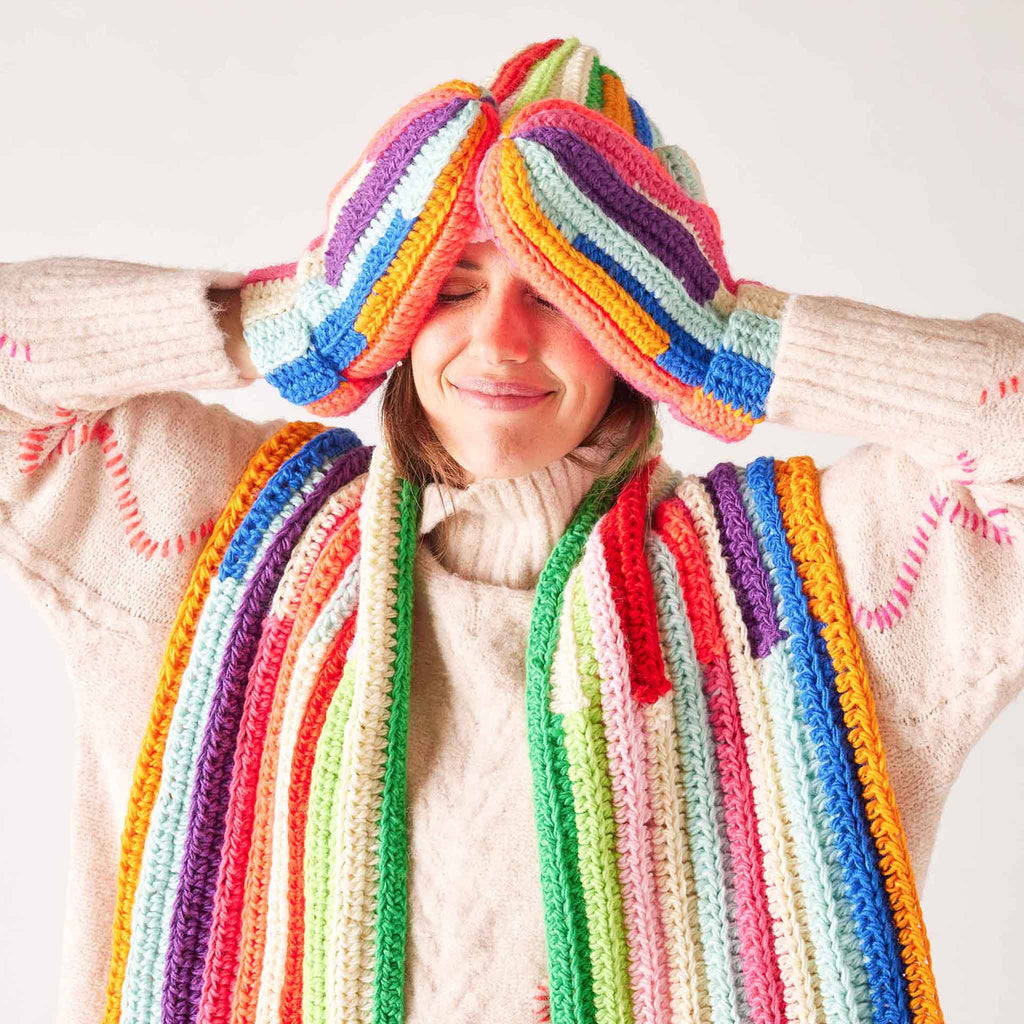 Mer-Sea Brightside Mittens in Kaleidoscope on model with matching beanie and scarf.