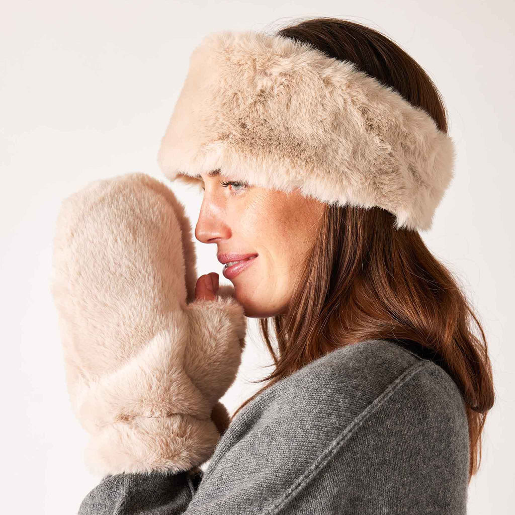 MERSEA Cozy Cabin Faux Fur Headband in beige, side view on model with matching mittens.