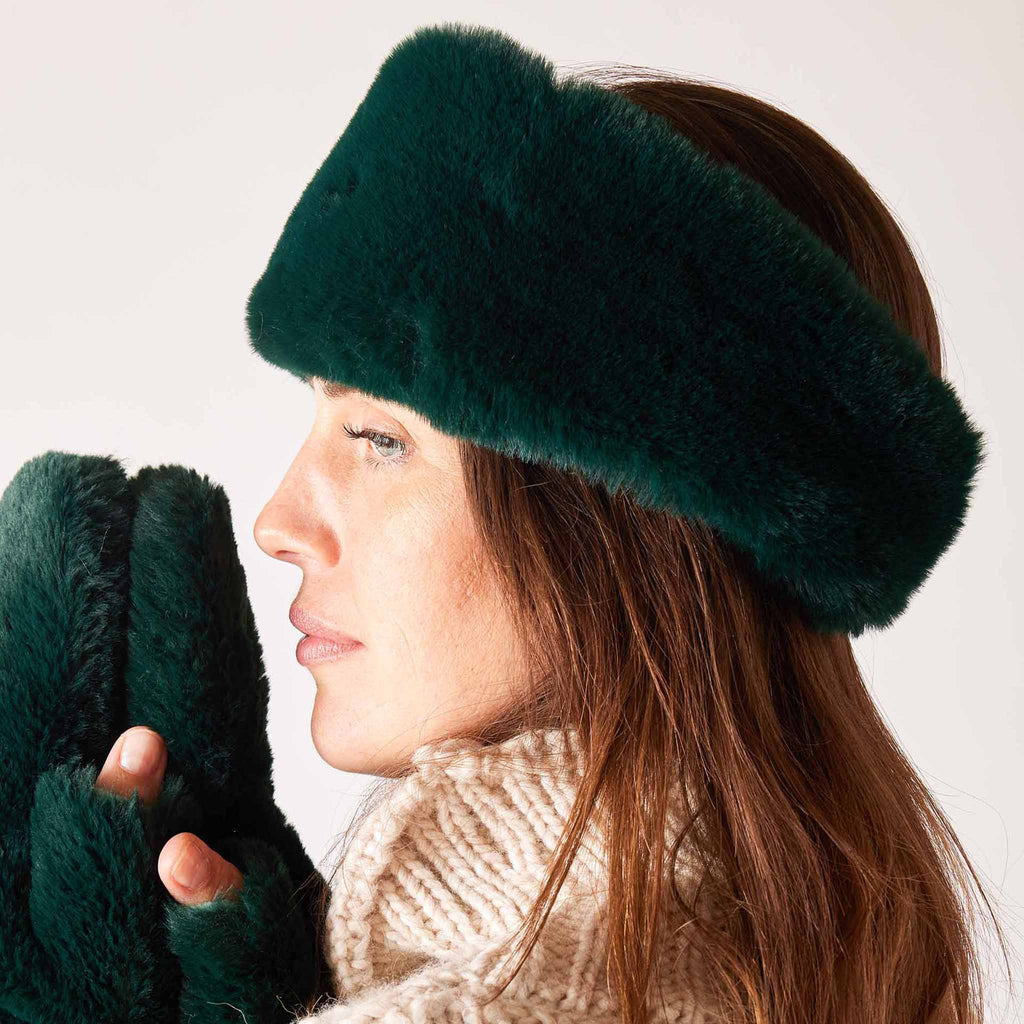 MERSEA Cozy Cabin Faux Fur Headband in green, side view on model with matching mittens.