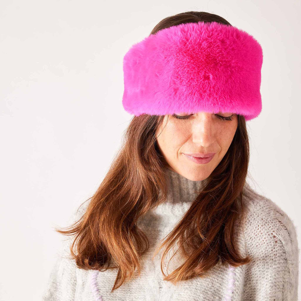 MERSEA Cozy Cabin Faux Fur Headband in hot pink, front view on model.