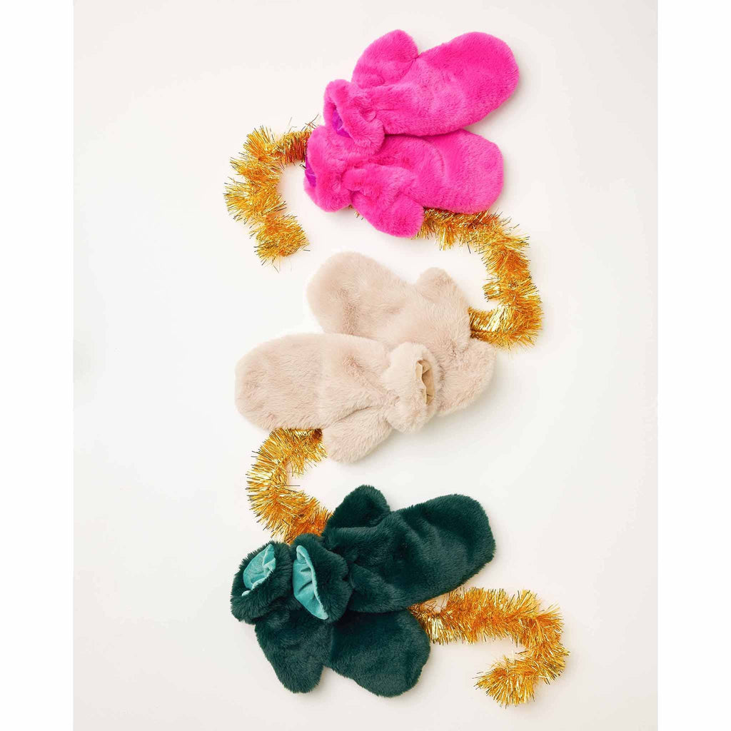 MERSEA women's cozy cabin faux fur mittens in 3 colors on white background with gold tinsel garland.