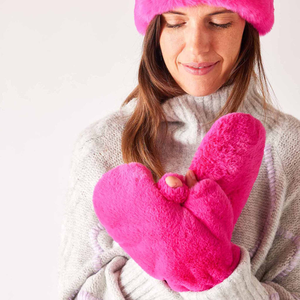 MERSEA women's ultraviolet hot pink cozy cabin faux fur mittens on model with matching headband.