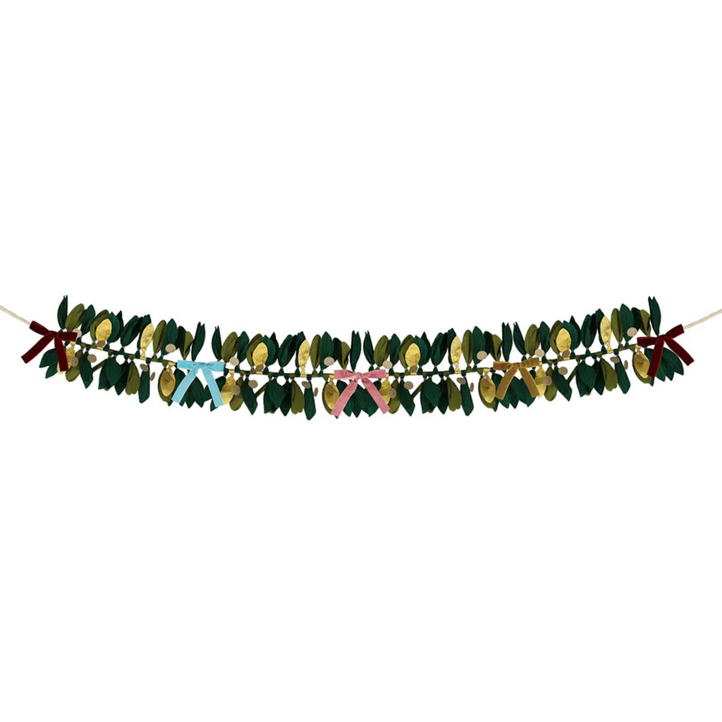 Meri Meri Paper Foliage Garland with crepe paper leaves in green and gold and velvet bows in rich red, dusty blue, dusty pink and mustard, stretched to show full length.