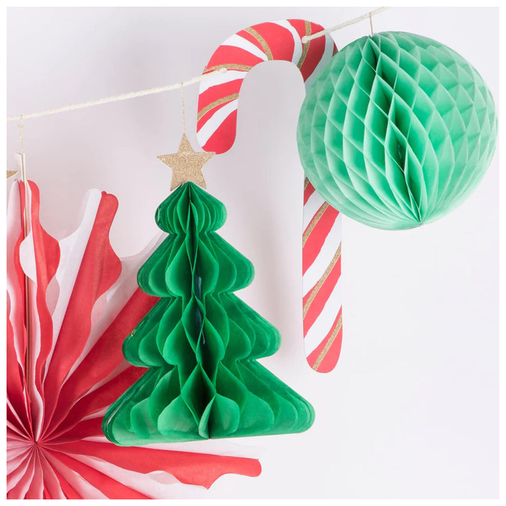 Meri Meri Christmas Honeycomb holiday garland, detail showing red and white striped honeycomb fan, dark green tree, candy cane and mint green ball.