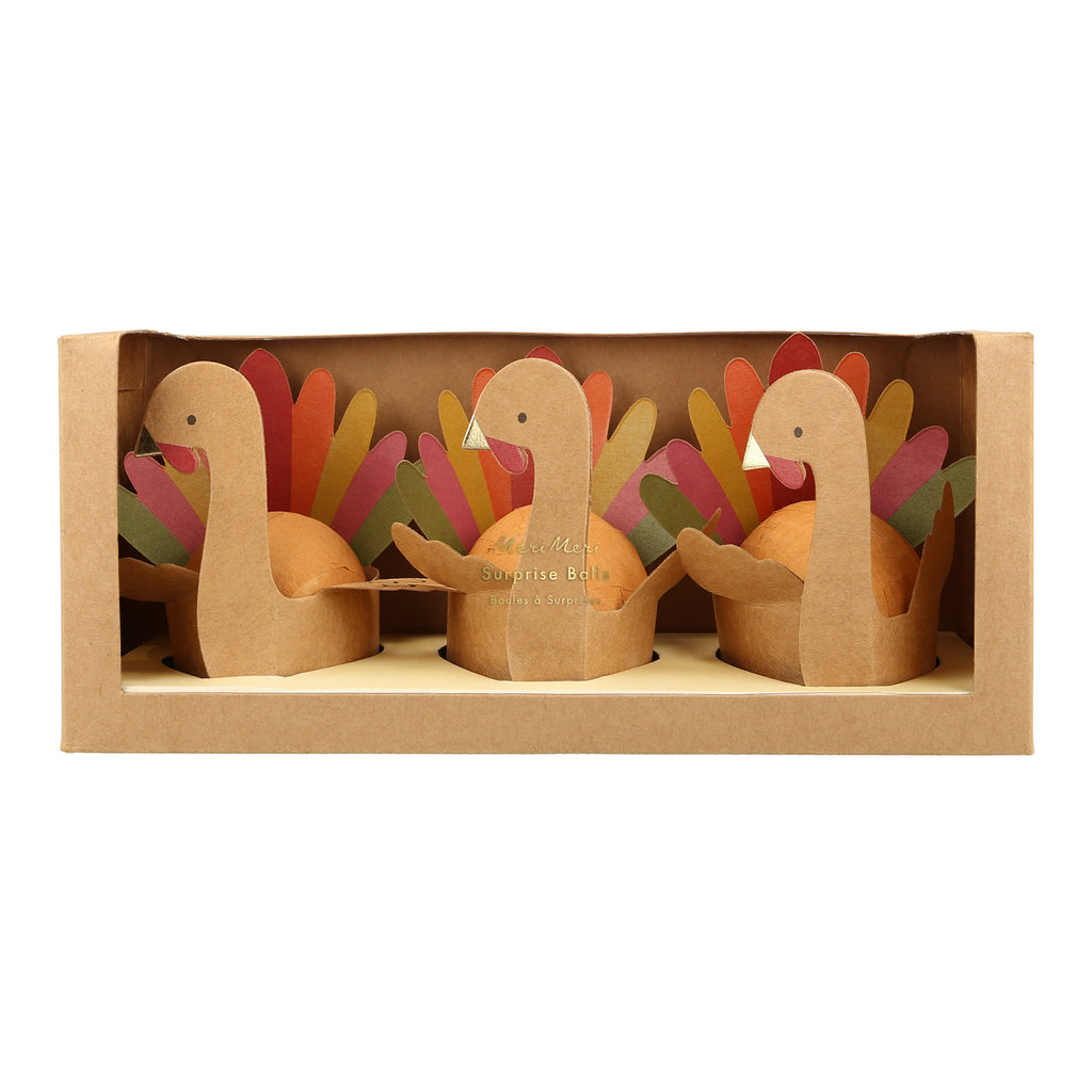 Meri Meri set of 3 Turkey Surprise Balls in kraft paper packaging, front view.