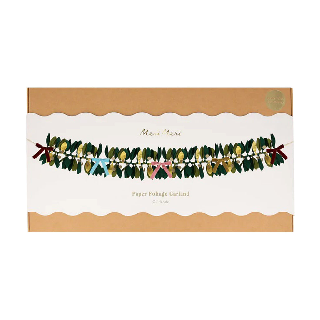Meri Meri Paper Foliage Garland with crepe paper leaves in green and gold and velvet bows in rich red, dusty blue, dusty pink and mustard, in box packaging, front view.