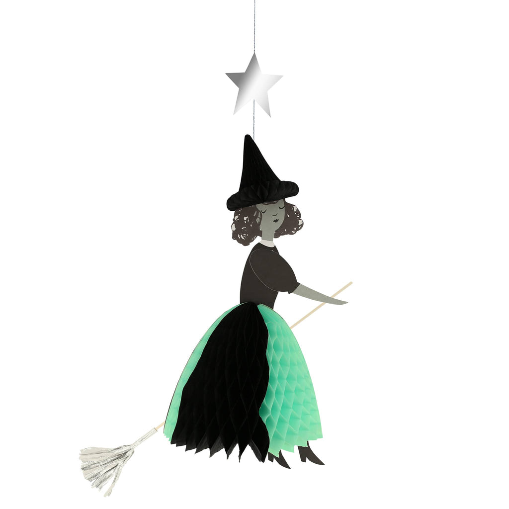 Meri Meri Flying Honeycomb Witch Halloween decorations, witch with black honeycomb hat, black and green skirt on a wood dowel broomstick with silver broom and a silver star on hanging thread.