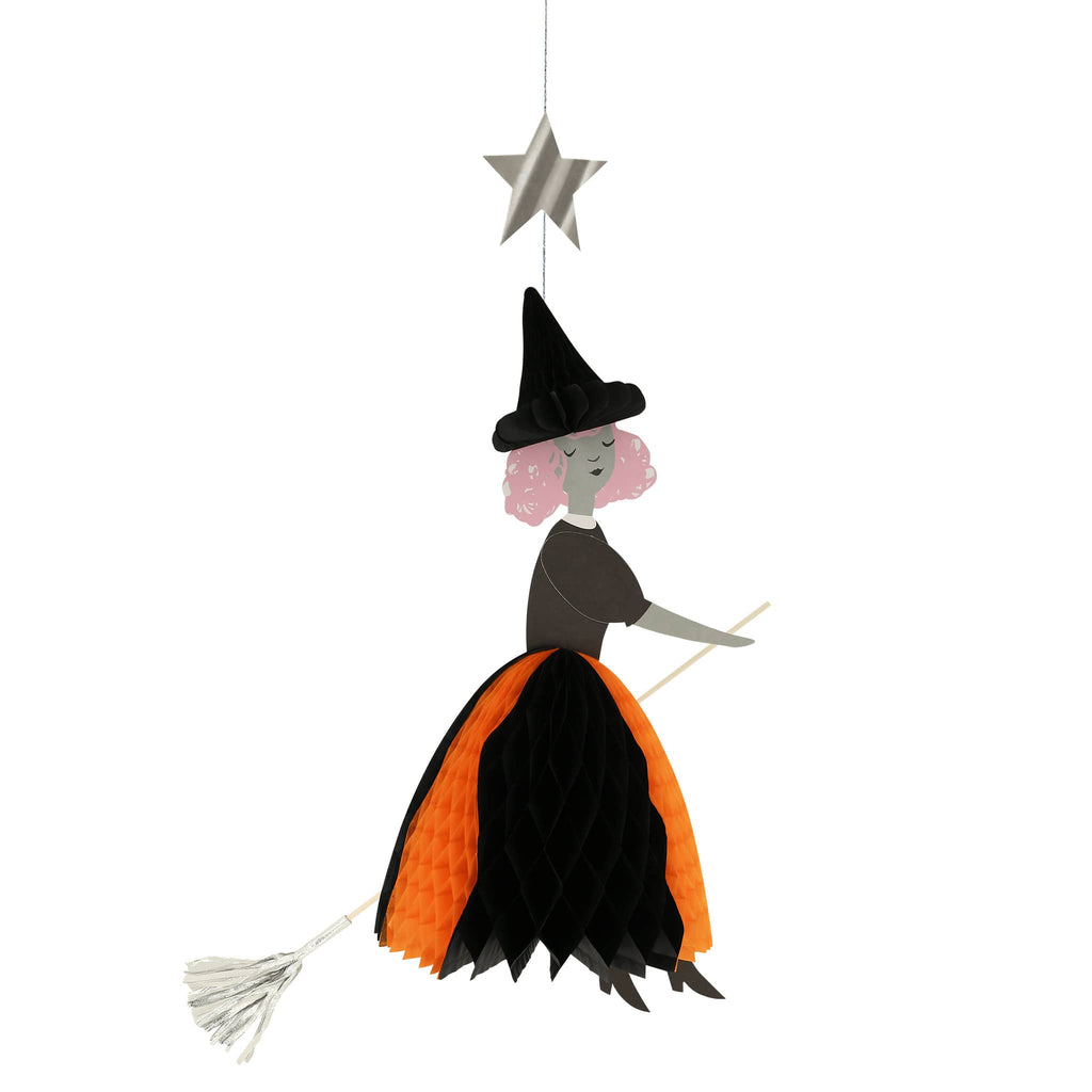 Meri Meri Flying Honeycomb Witch Halloween decorations, witch with black honeycomb hat, black and orange skirt on a wood dowel broomstick with silver broom and a silver star on hanging thread.