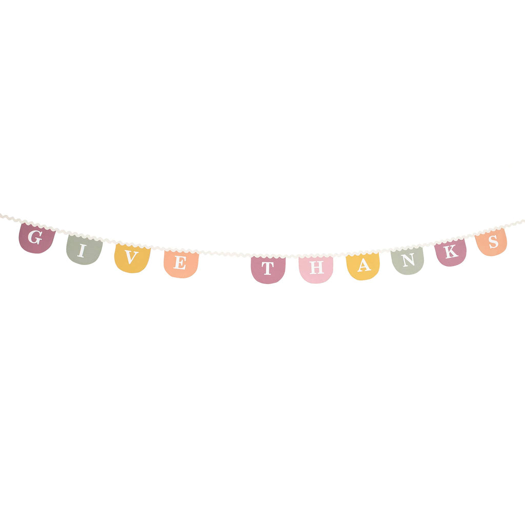 Decorative fabric banner with 'Give Thanks' text on pastel pennants, on a white background.