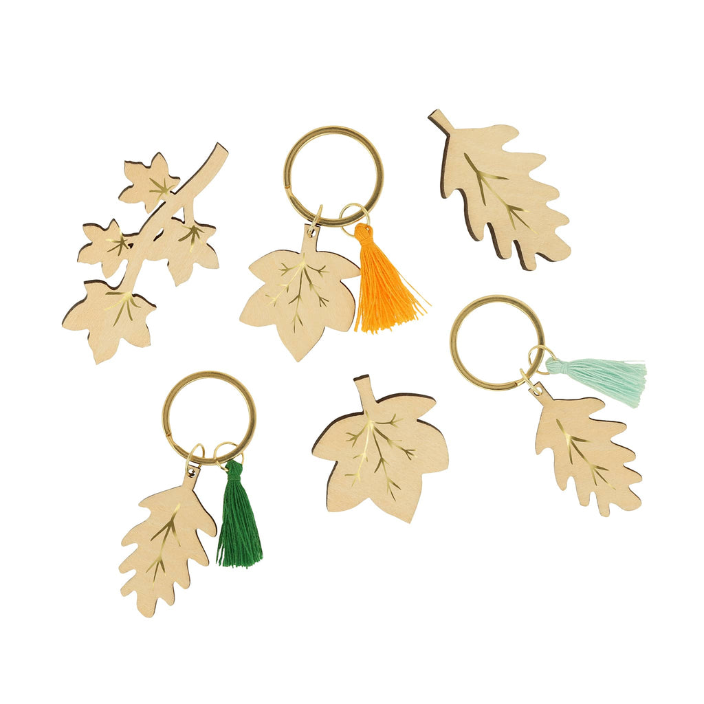 Meri Meri Gold Leaf holiday surprise crackers, wood leaf keychain and brooch styles.