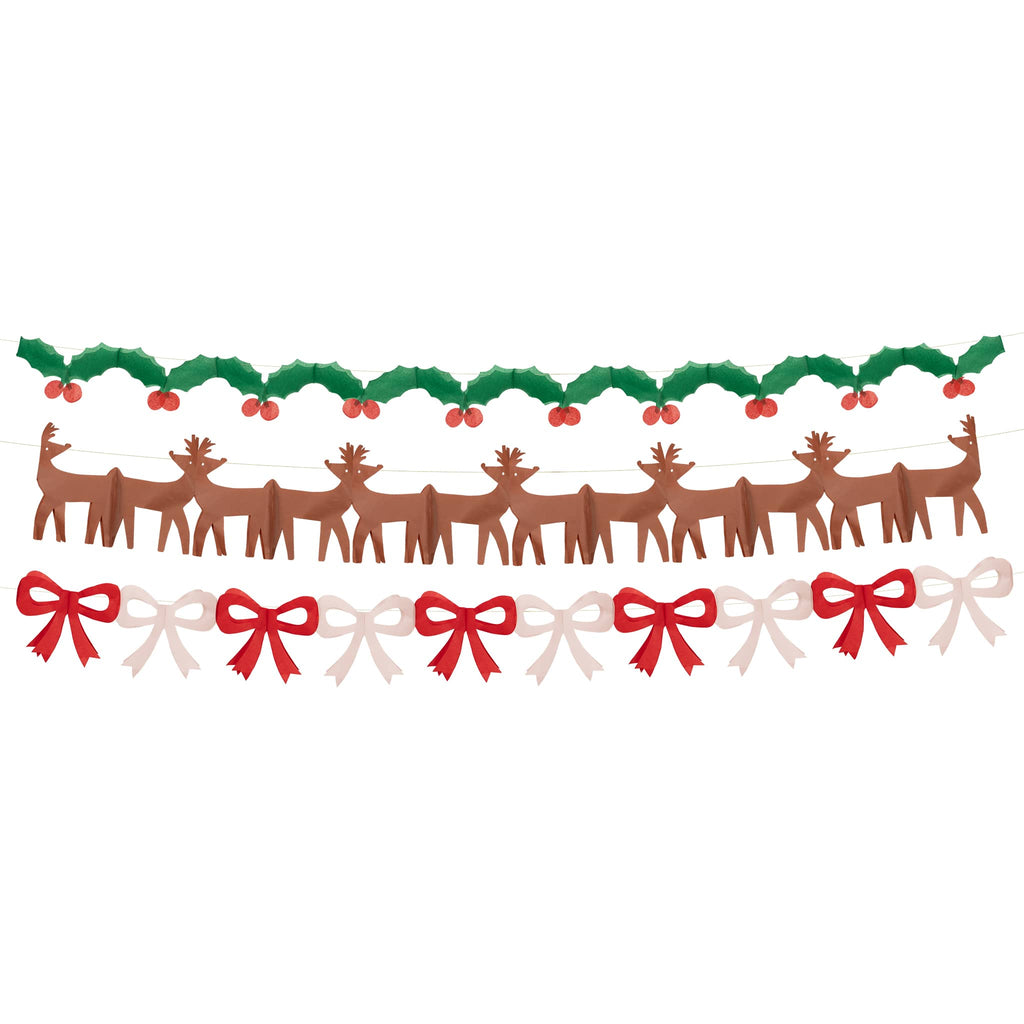 Decorative tissue paper garlands with reindeer, holly, and bow designs.